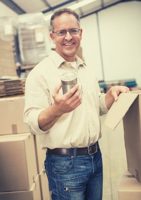 man smiling at work in a manufacturing facility
