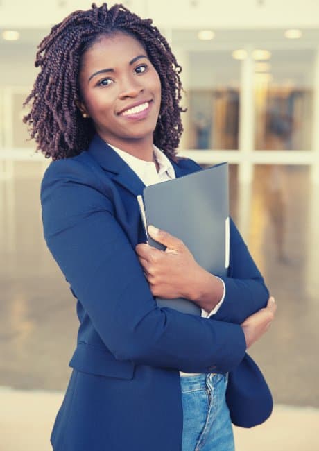 woman carrying paperwork in a school