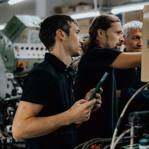 Engineers working on renewable energy technology in a factory setting.